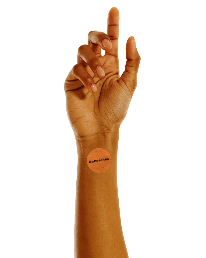 Hand with a Boost Patch on the wrist against a white background